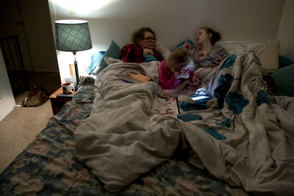 First Place, Feature Picture Story - Jessica Phelps / Newark Advocate, “Living on Love”On a chilly winter night Sophia and Kyndall both climbed into their mom, Leah Hrebluk's bed March 11, 2020. The trio are extremely close and do everything together. 